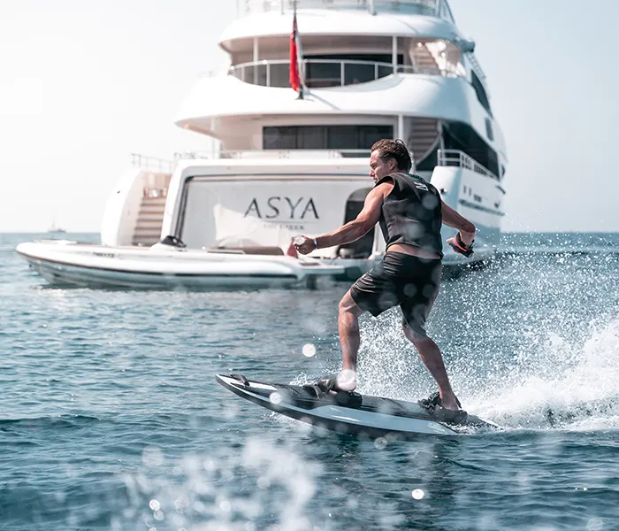 Awake RAVIK S jetboard man surfing in front of a yacht